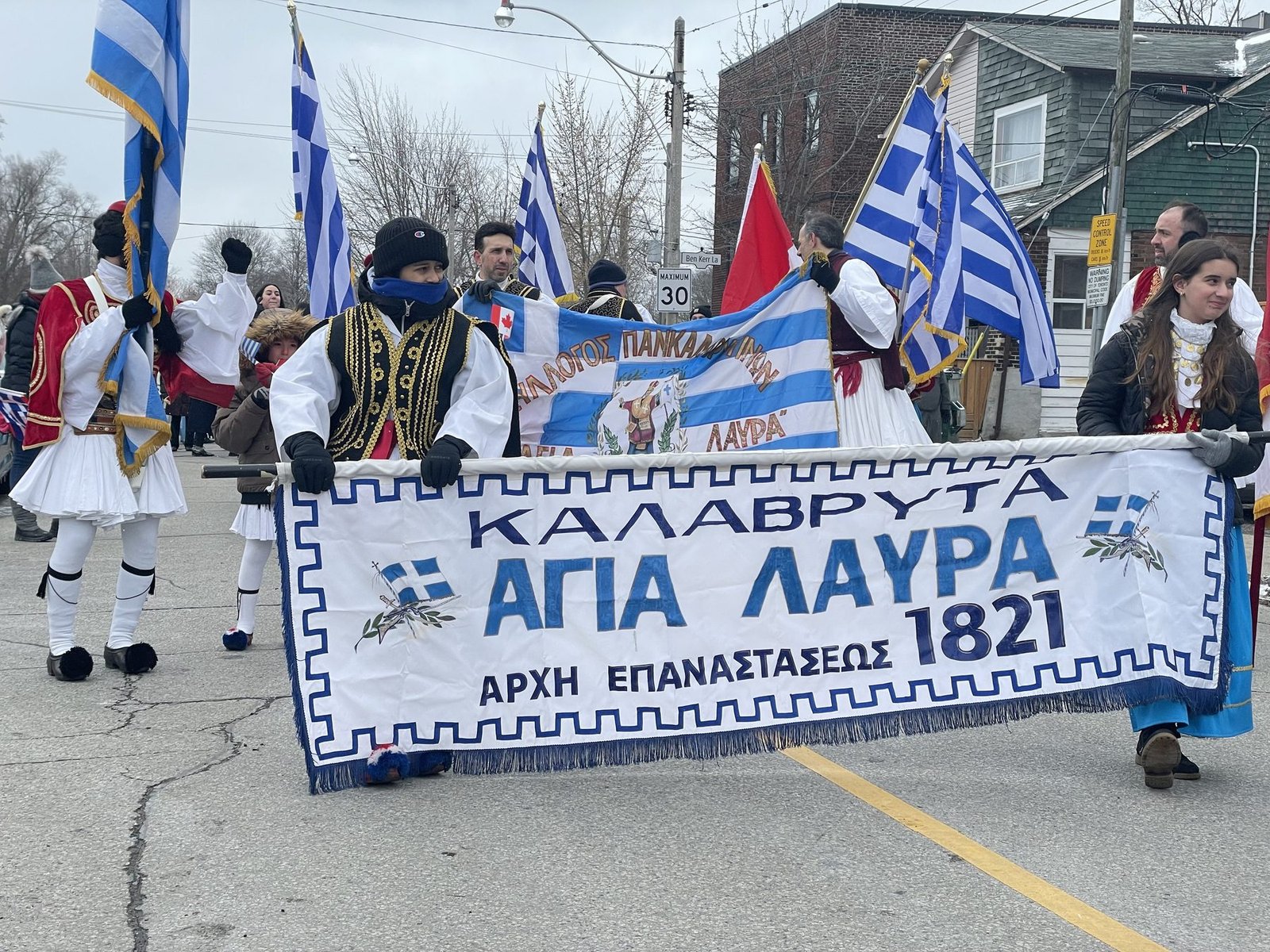 Members carrying the Kalavryta – Agia Lavra banner at the Greek Independence Day parade in Toronto
